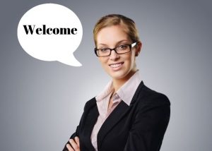 Image contains a woman saying "Welcome".